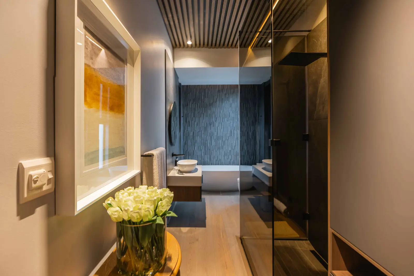 Bathroom interior with round mirror, wall sconces, and neutral finishes in Steyn City – Renovatio Interiors Johannesburg.