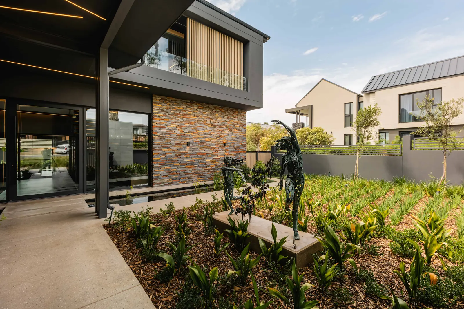 Front garden and walkway of modern Steyn City residence designed by Renovatio Interior Design Johannesburg.