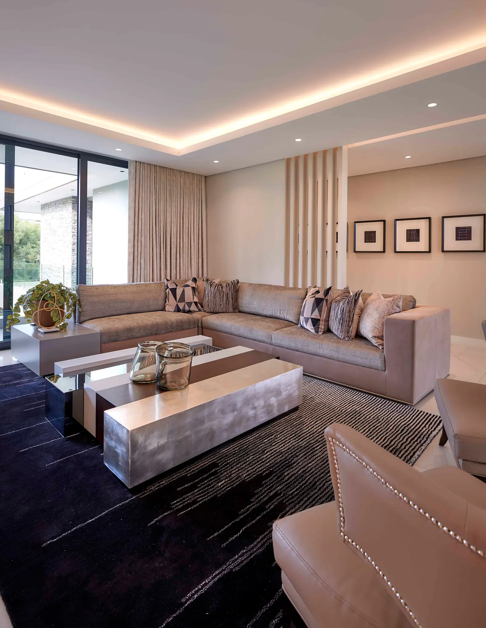 Luxurious dining room with statement lighting and contemporary chairs by Interior Designer Johannesburg.