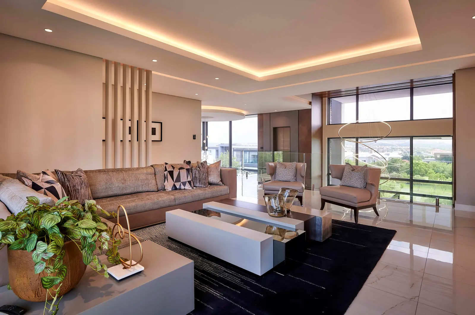 Chic living room with neutral palette and lush indoor plants styled by Interior Designer Johannesburg.