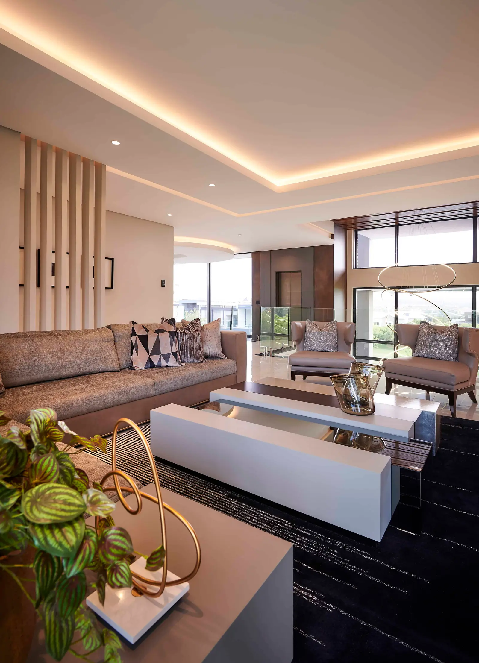Cozy seating area with fireplace and plush cushions created by Interior Designer Johannesburg.