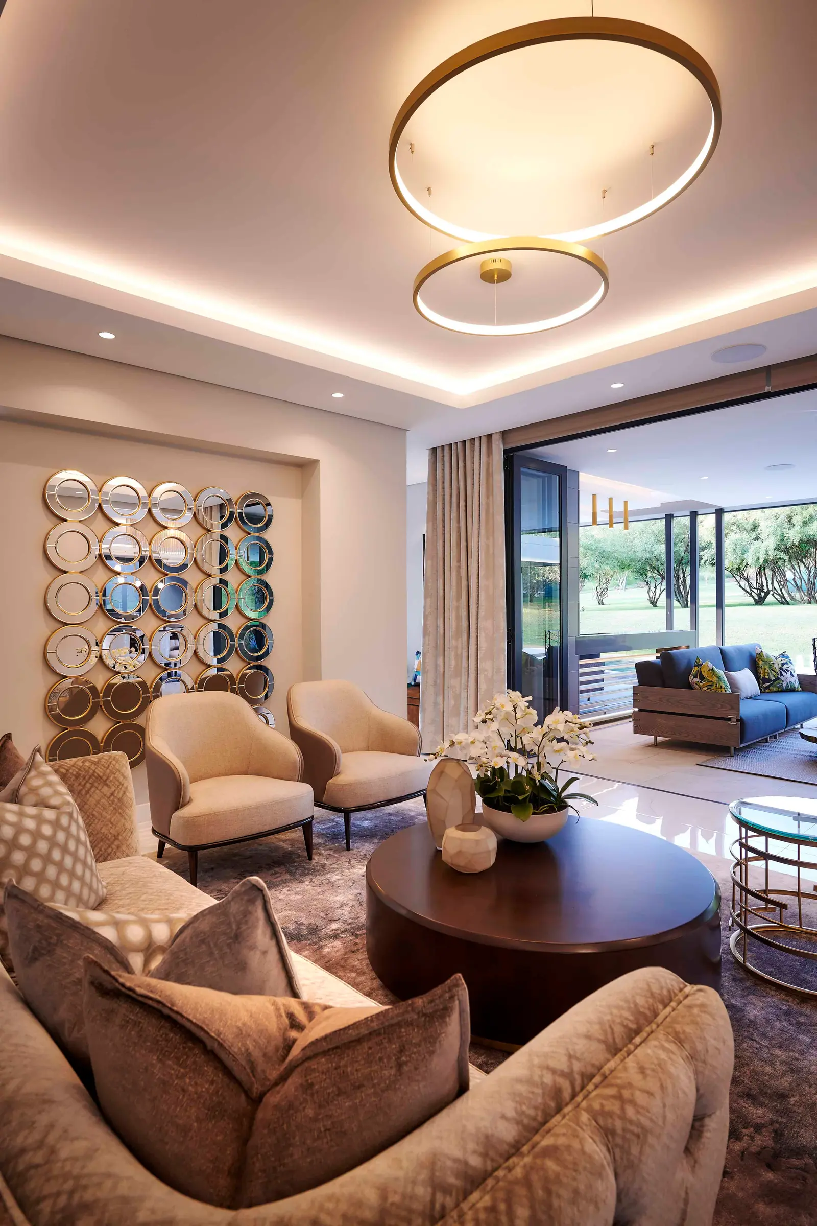 Elegant living room with statement chandelier and comfortable sofa by Interior Designer Johannesburg.