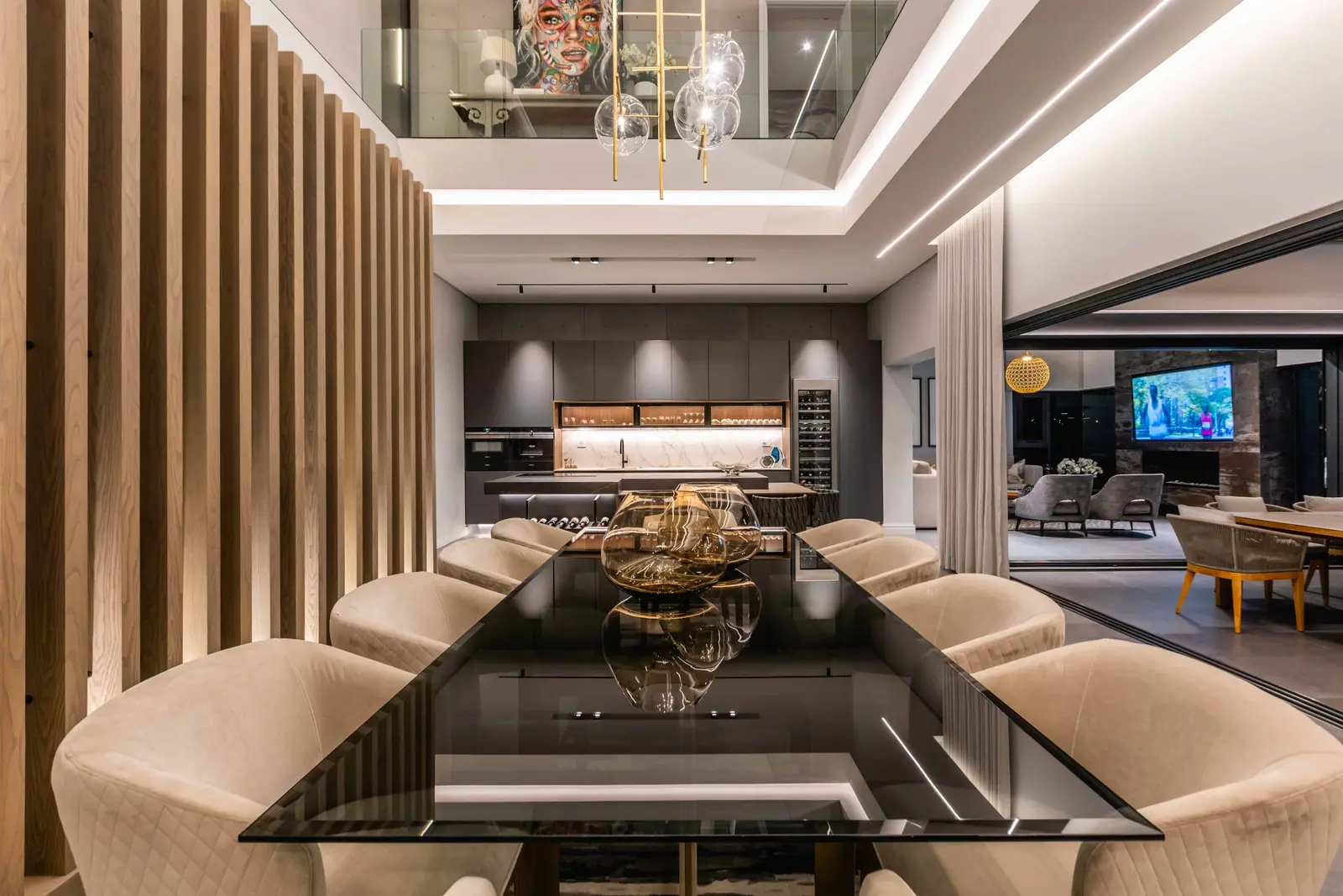 Dining room beside vertical timber slats and artwork, modern Steyn City residence – Renovatio Interiors.
