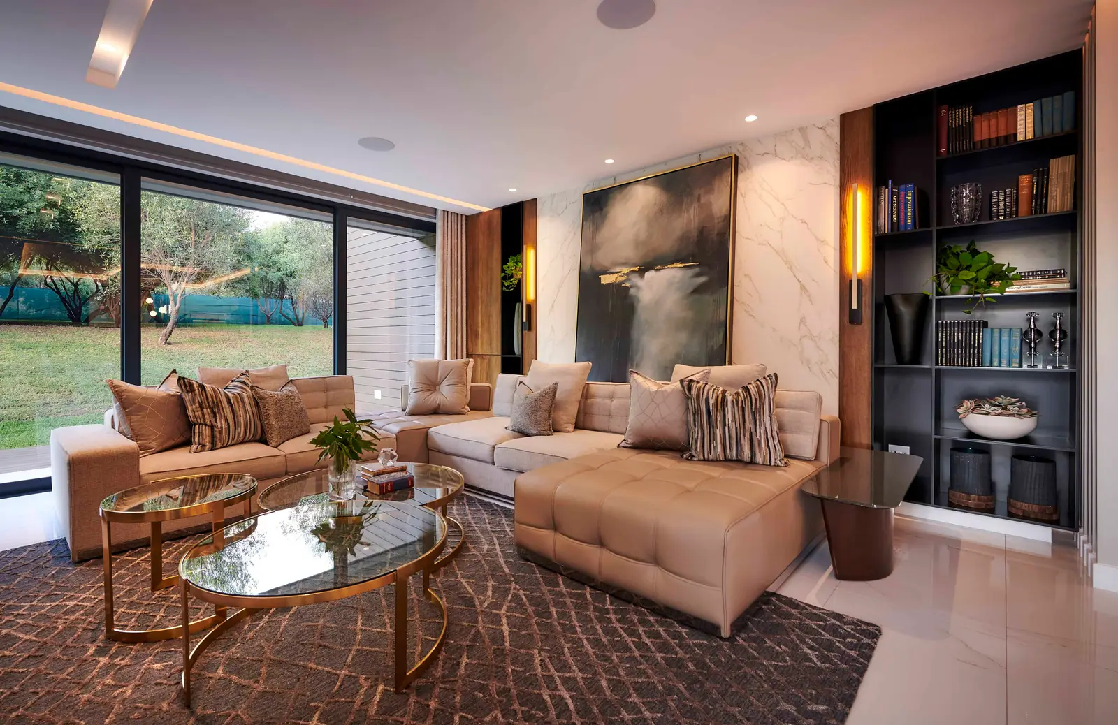 Spacious living room with sectional sofa, large windows and timber detail designed by Interior Designer Johannesburg.