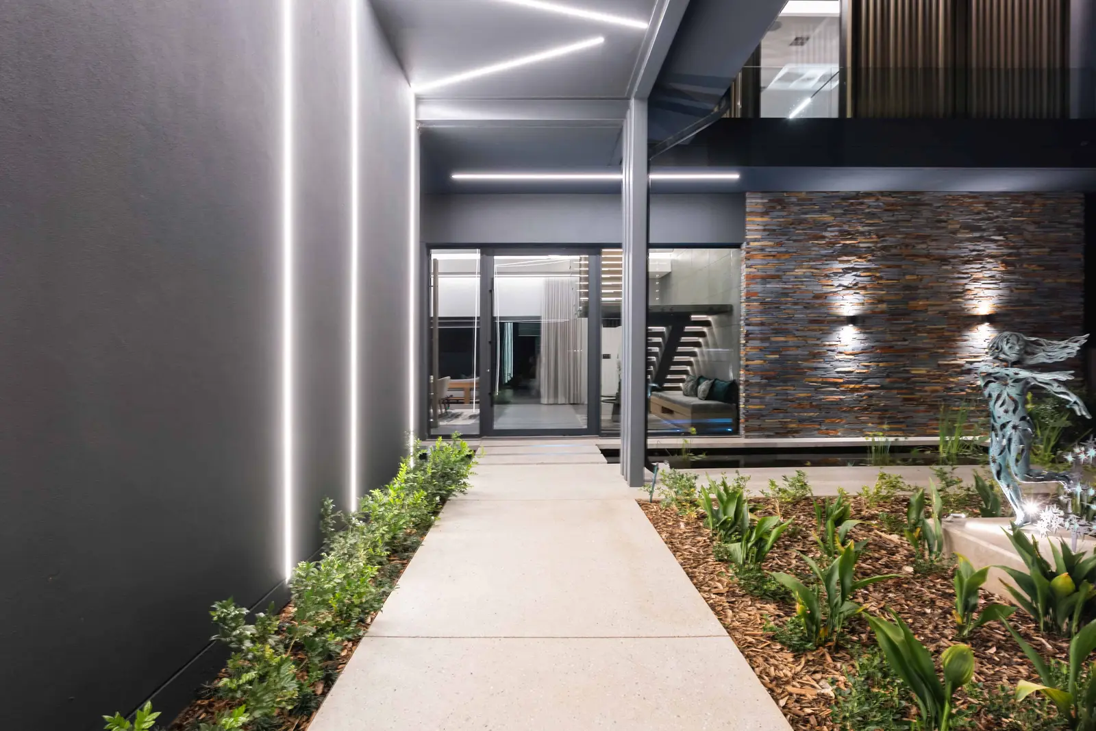 Night walkway and architectural lighting at a Steyn City residence – Renovatio, Johannesburg interior design.
