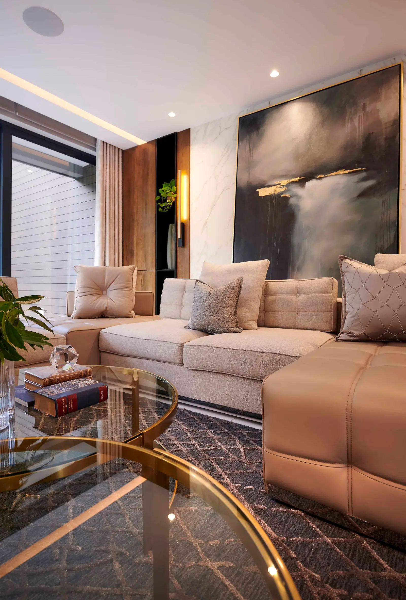 Bright living space with double-volume ceiling and statement bookshelf by Interior Designer Johannesburg.