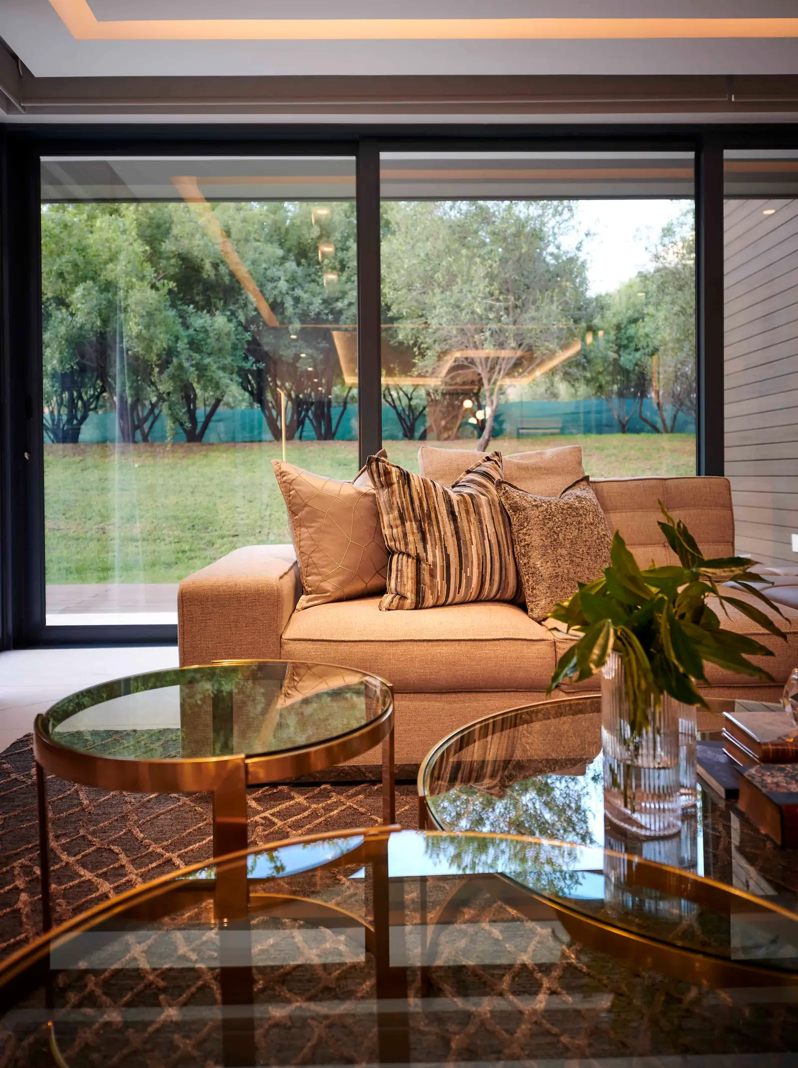 Lounge with garden views, rattan furniture and neutral palette styled by Interior Designer Johannesburg.