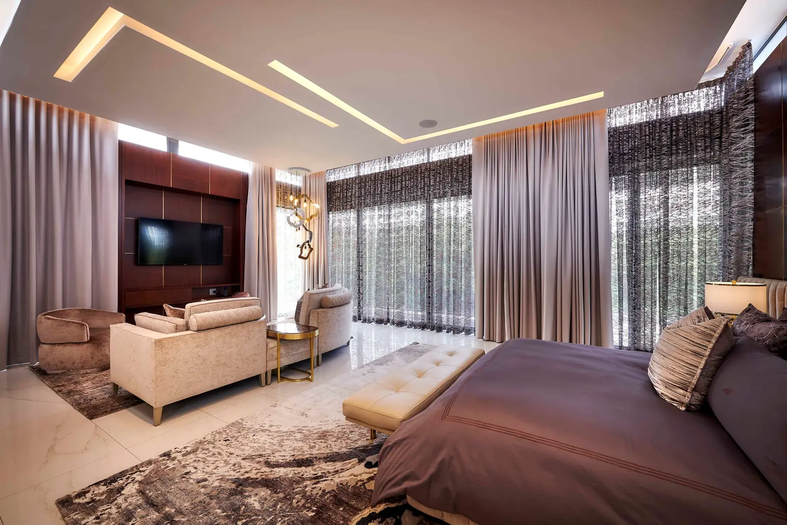 Bright open‑plan lounge with modern seating, media unit and natural light, designed by Interior Designer Johannesburg.