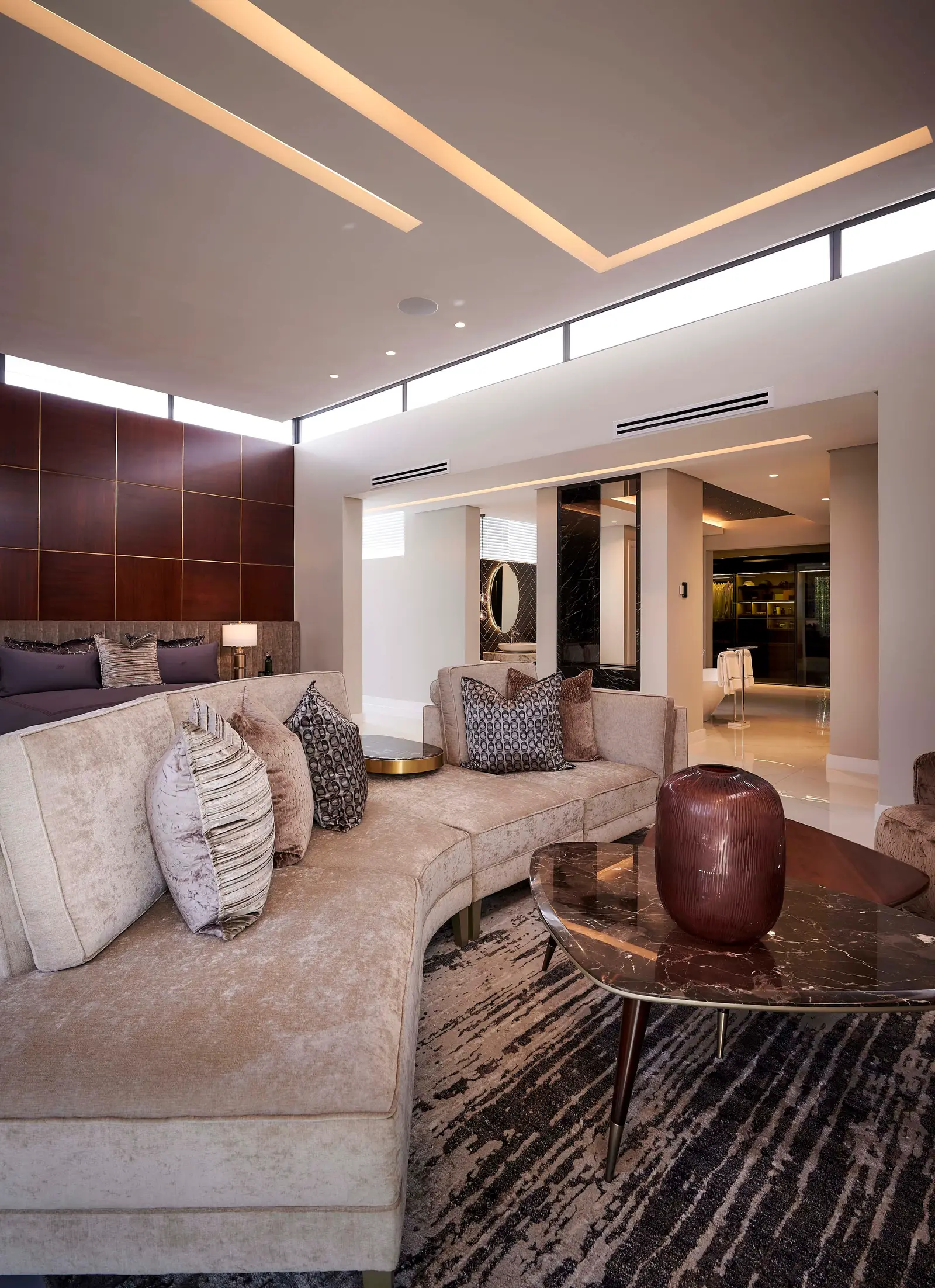 Large contemporary living area with comfortable seating, high ceilings and sophisticated decor curated by Interior Designer Johannesburg.