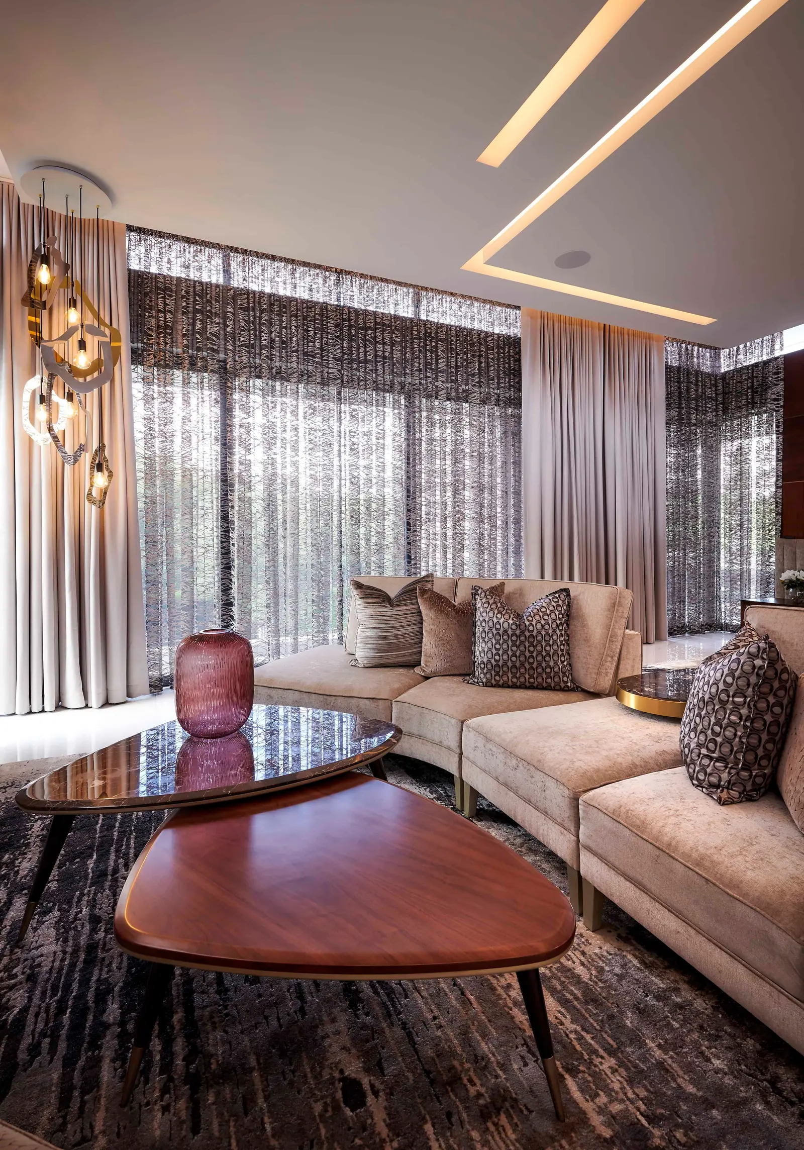 Sunlit lounge with wooden accents, cozy seating and neutral palette created by Interior Designer Johannesburg.