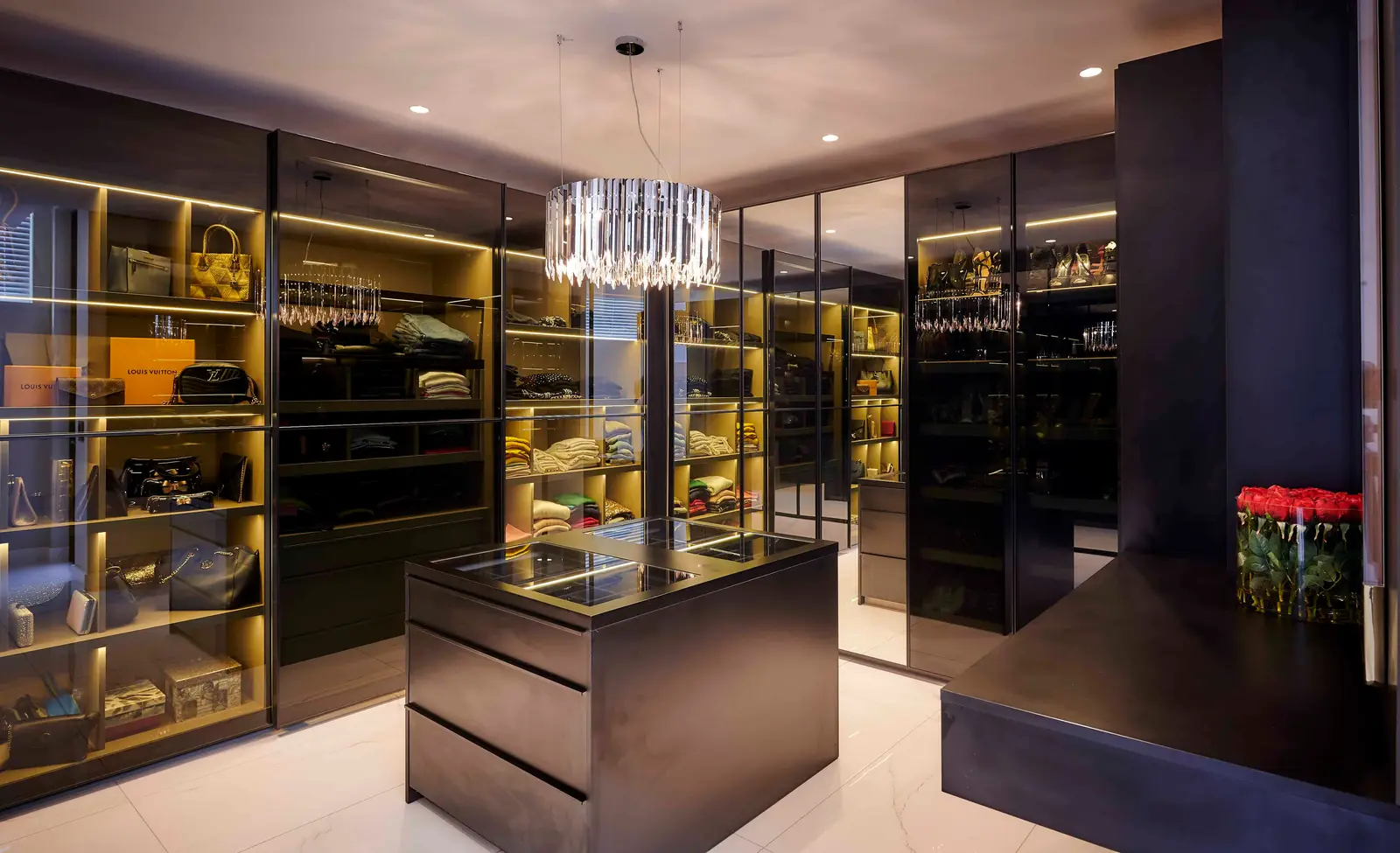 Sleek walk‑in closet with glass display and modern shelving created by Interior Designer Johannesburg.