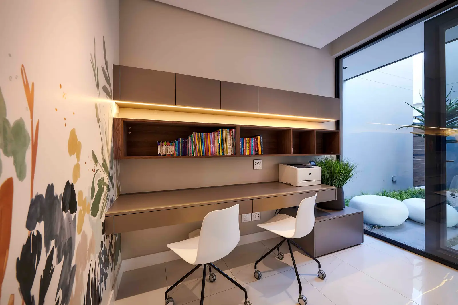 Modern study or home office with built‑in shelves, desk space and natural lighting designed by Interior Designer Johannesburg.